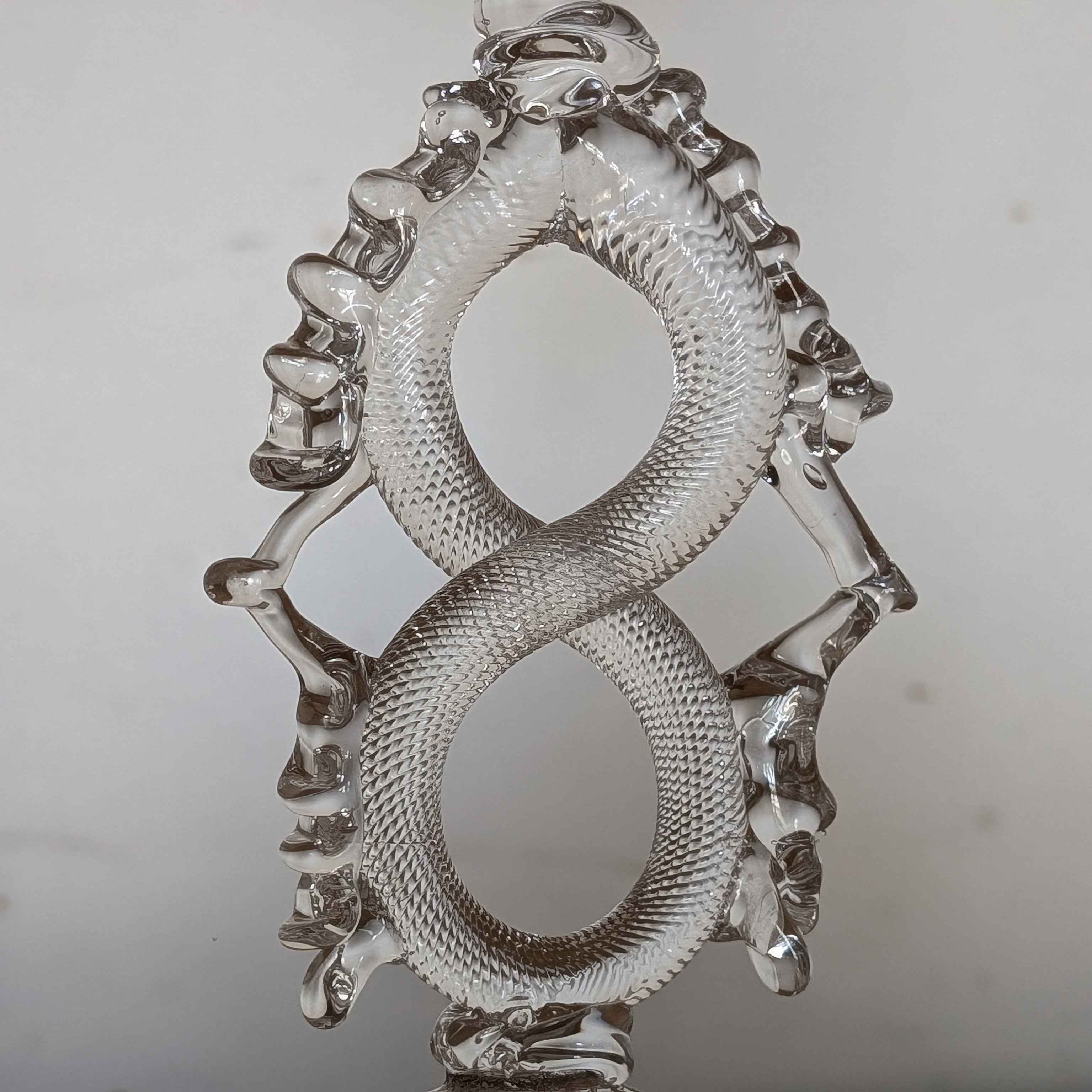 Material: Glass<br><br>
     Glass is a delicate material that originates from sand, powder, or dust. There are
     different bases used to create glass, and one of them is named silica sand. It is
     a small dust that determines the quality, clarity, and strength of the glass depending
     on how much is used. It is the primary source used in Sheridan College's glassmaking
     laboratory, as it is also the best sustainable option. During the glassmaking process,
     the glass starts as a crystal blob which is continuously reheated in the furnace. It is
     then to shaped by cutting or bending.