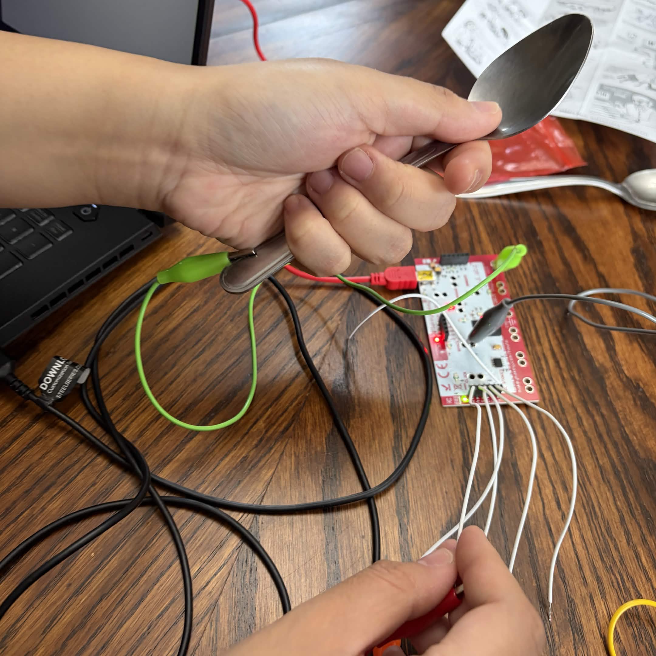 Experimenting with the backside of the Makey Makey with the spoon as a ground.