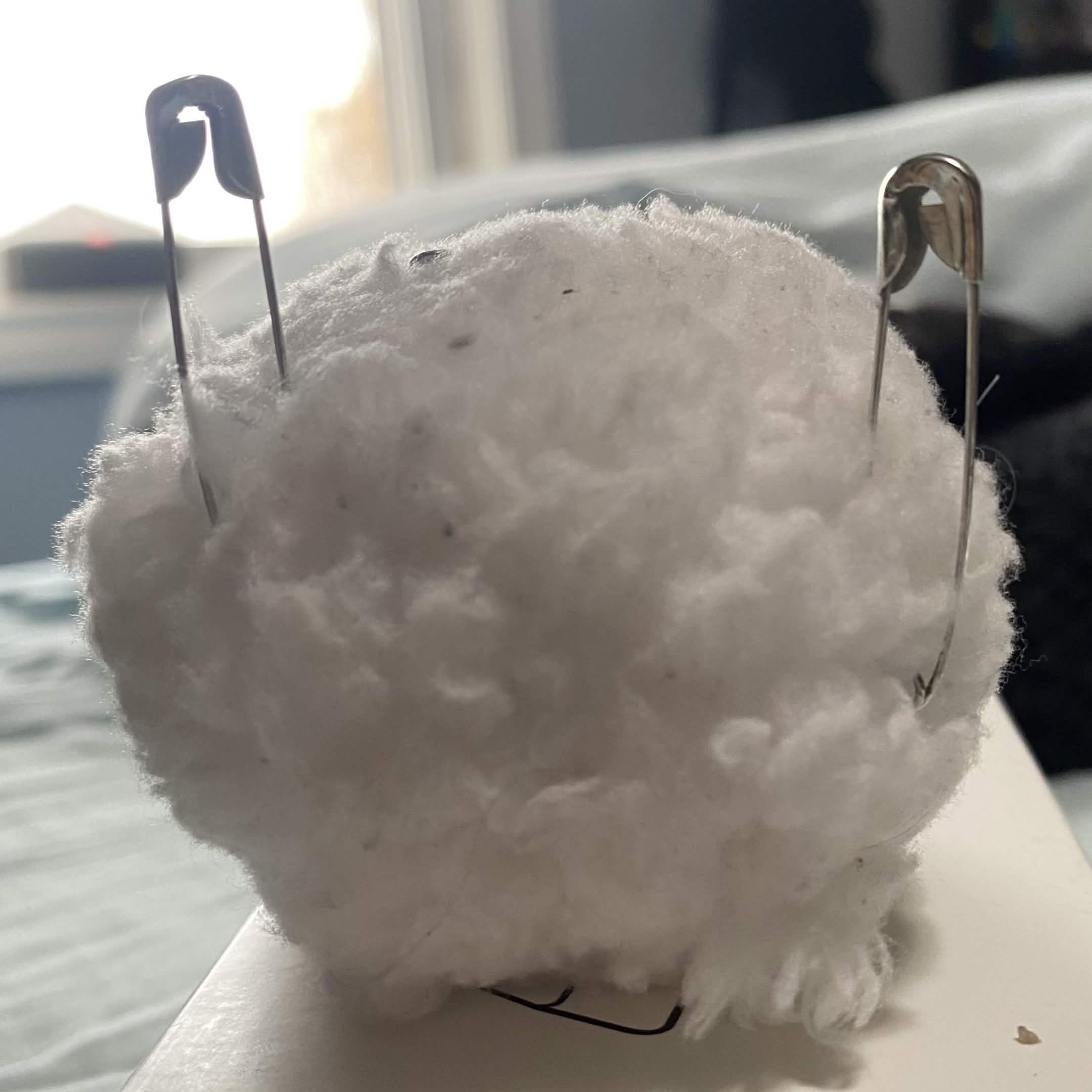 Fluff ball prototype. Added safety pins to emulate ears and for conductivity.