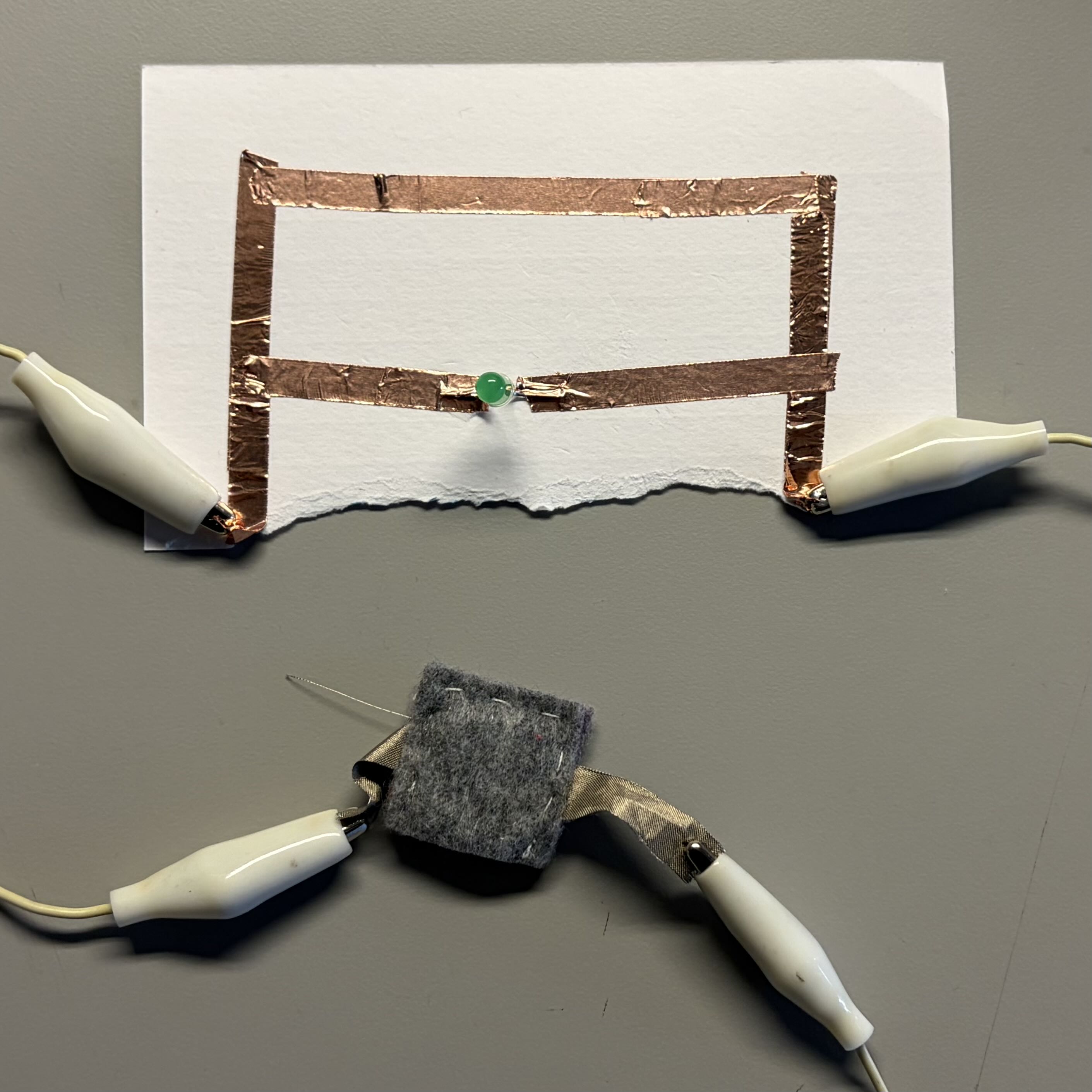 Initial tests of experimenting with alligator clasps and the battery inside felt