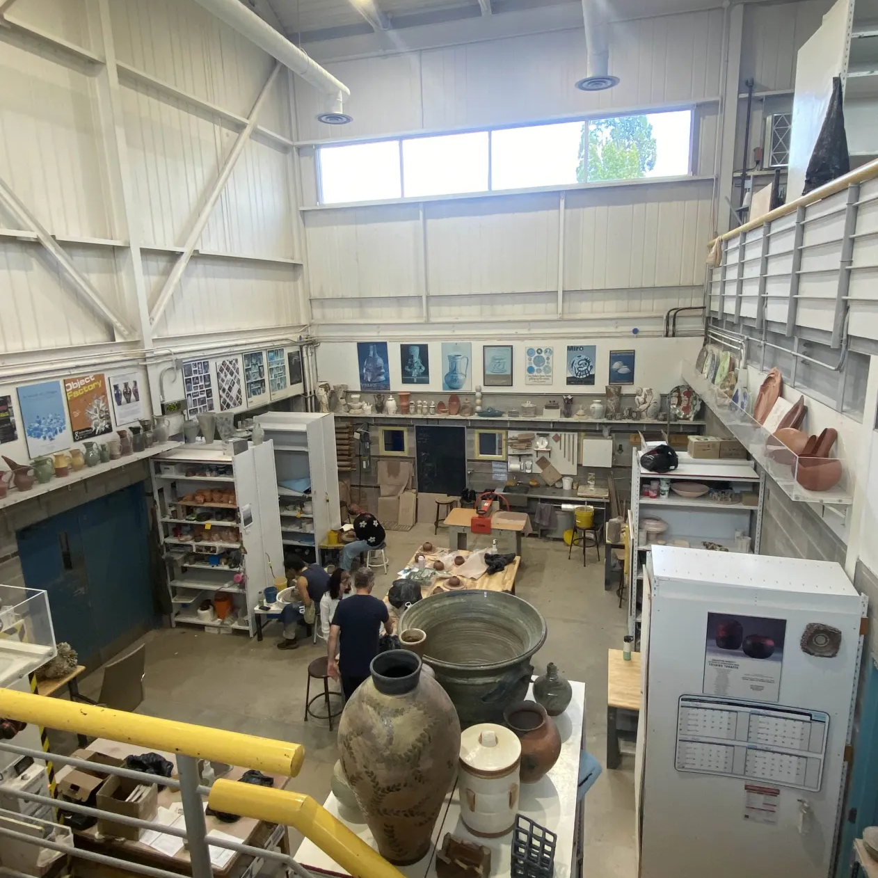 The ceramics lab.<br> Majority of the space is made out of concrete and as the name states, includes
                ceramic projects stored in shelves. The area of this lab is small and narrow which means it can get chaotic or messy
                during work hours. However, the color and the chaos gives the impression that it is a student
                laboratory. There is natural lighting above from the window.